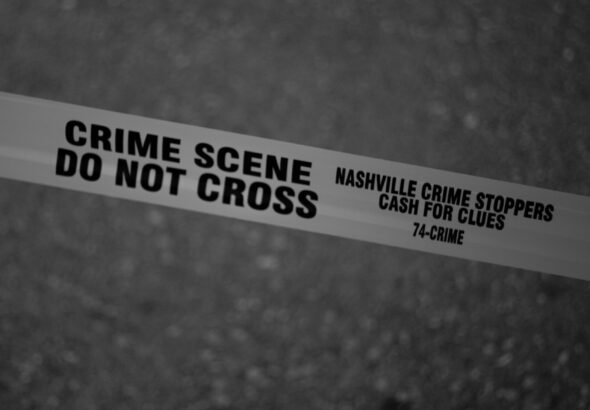 Black and white close-up of crime scene tape with Nashville text.